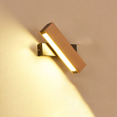 Wooden LED wall lamp mounted beside a bed